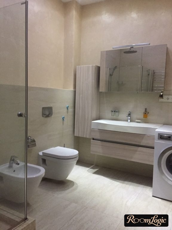 65-square-foot bathroom with a shower and washer
