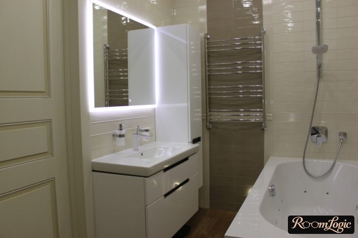 a mirrored vanity with backlighting in a small bathroom