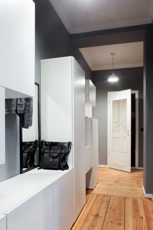 a narrow hallway entryway with a closet