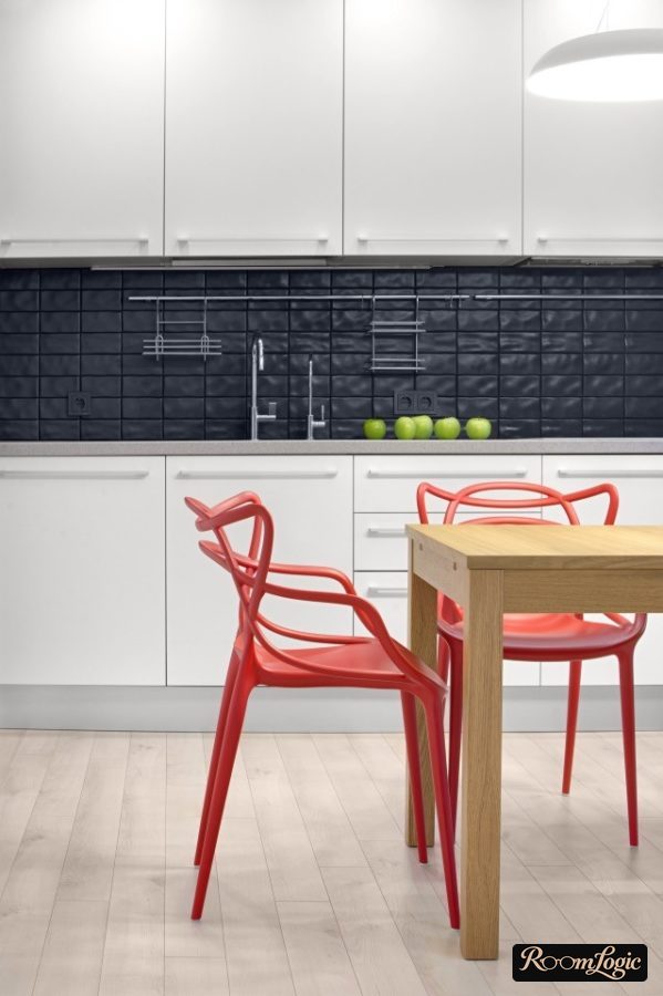 a red designer chair in a white kitchen