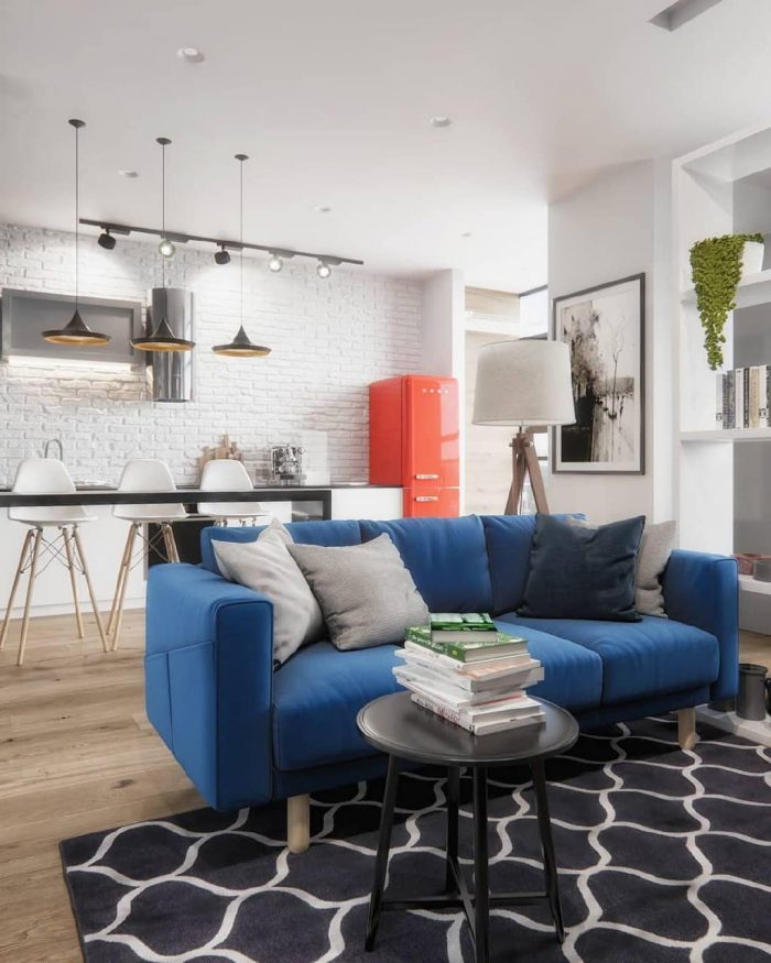 accent blue sofa in a modern Scandinavian studio apartment