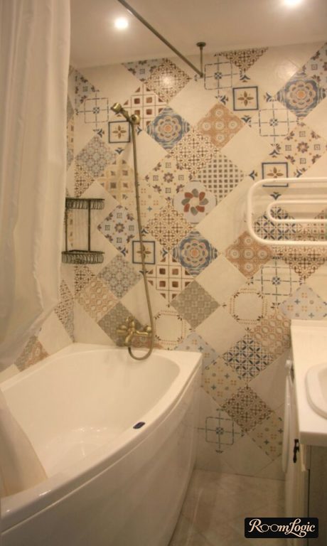 Accent wall patchwork in the bathroom of a tiny apartment