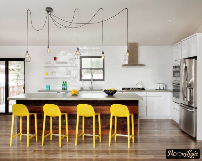 Backsplash of white glossy brick tiles extending to the ceiling in the corner kitchen without overhead cabinets