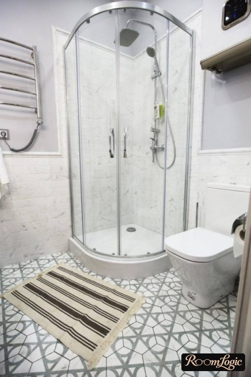 bathroom design with shower nook and toilet