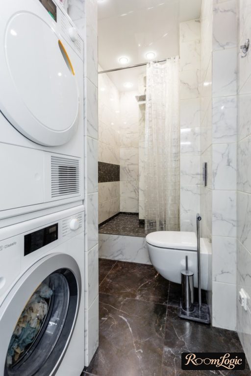 bathroom design with toilet and washer