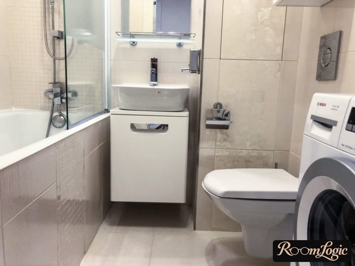 bathroom in a tiny apartment with toilet and washer
