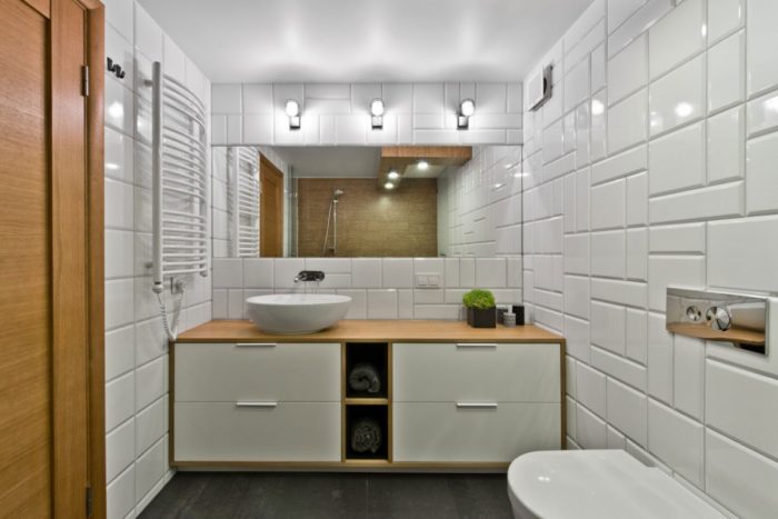 Bathroom in Scandinavian style with white glossy tile