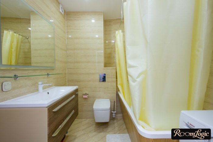 bathroom interior with washer in glossy tile
