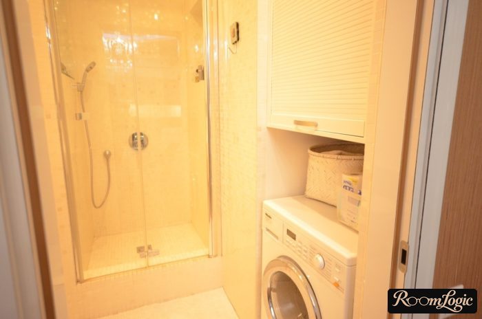 bathroom with shower and washer