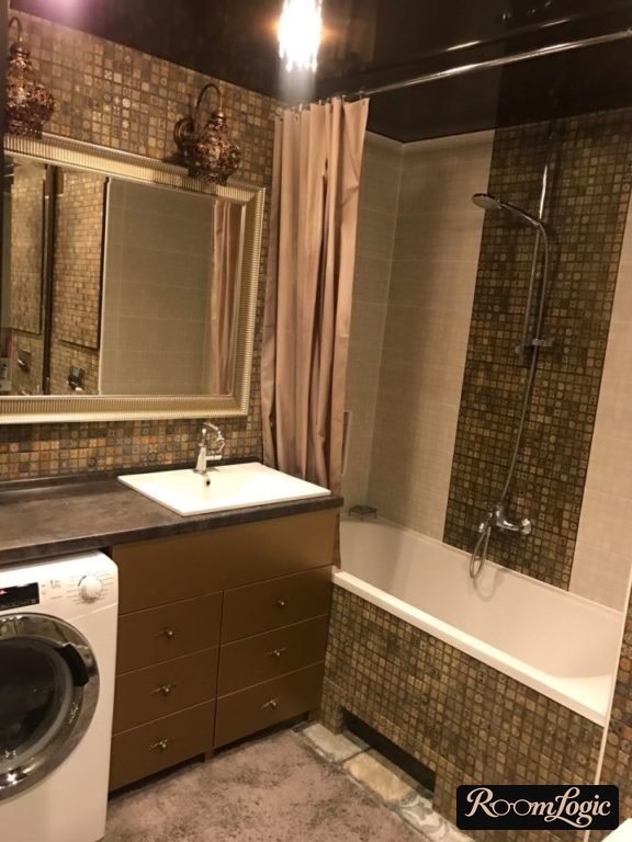 bathroom with washer under sink