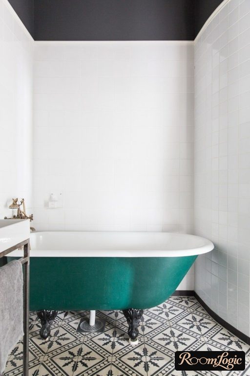 bathtub on legs and tile with a pattern