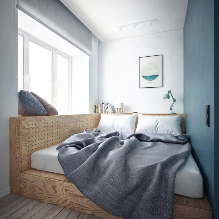 bed on a platform in a small bedroom