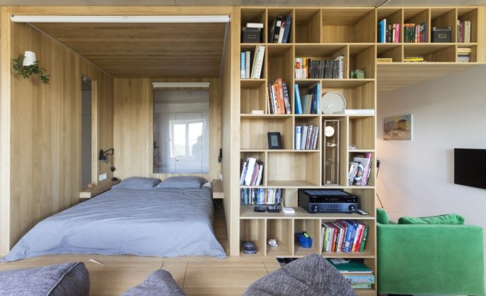 bed on a platform in studio apartment