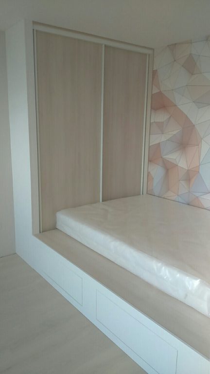 bed on a platform with storage drawers