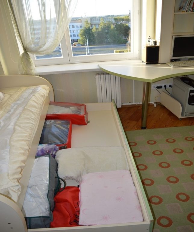 bed with pull-out drawer and storage underneath