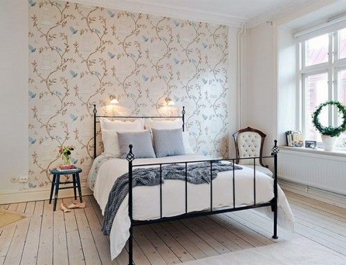 bedroom with wallpaper on part of the wall