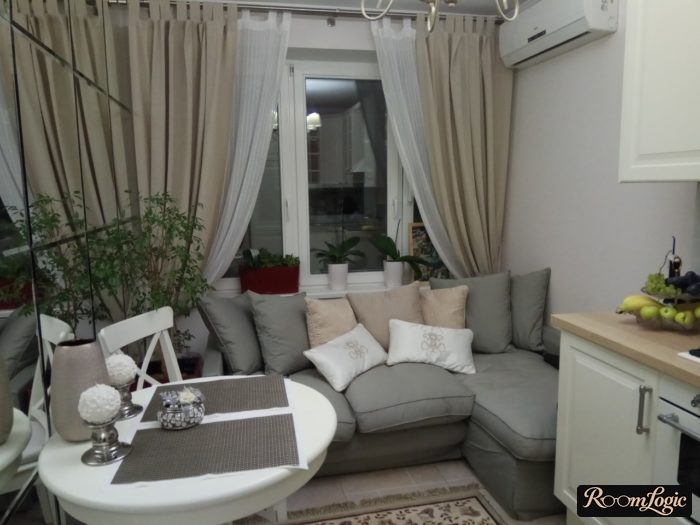 Beige curtains floor-to-ceiling in the kitchen with a sofa