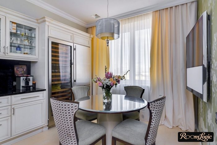 Beige curtains in a kitchen with a balcony door in a modern classic style