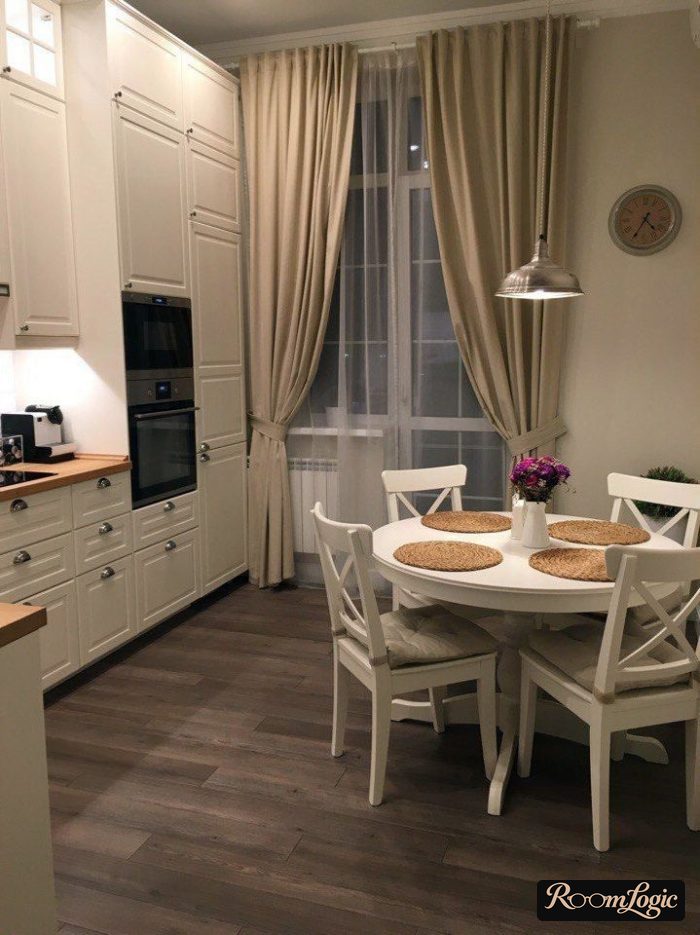 Beige curtains in the kitchen interior with a balcony