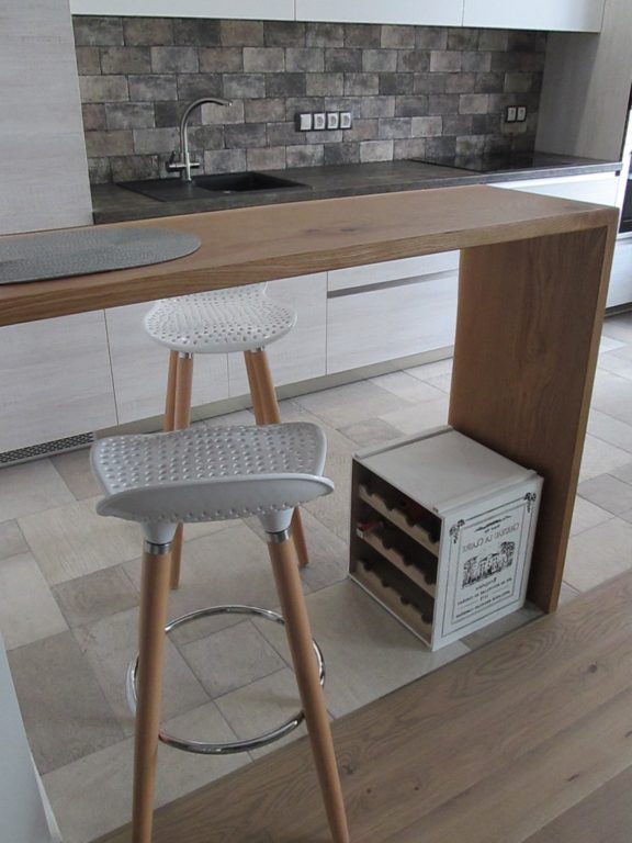 Beige kitchen with a wooden breakfast bar
