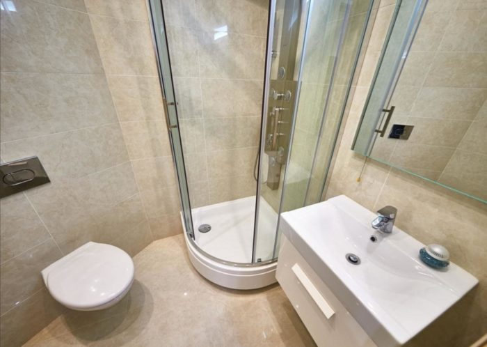 beige tile in the bathroom with a shower