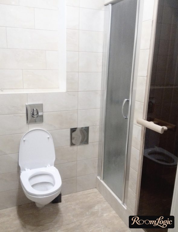 Beige tile in the toilet with a shower