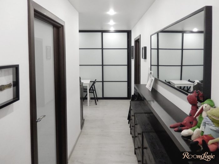 black and white entryway with a hallway featuring an open shelf