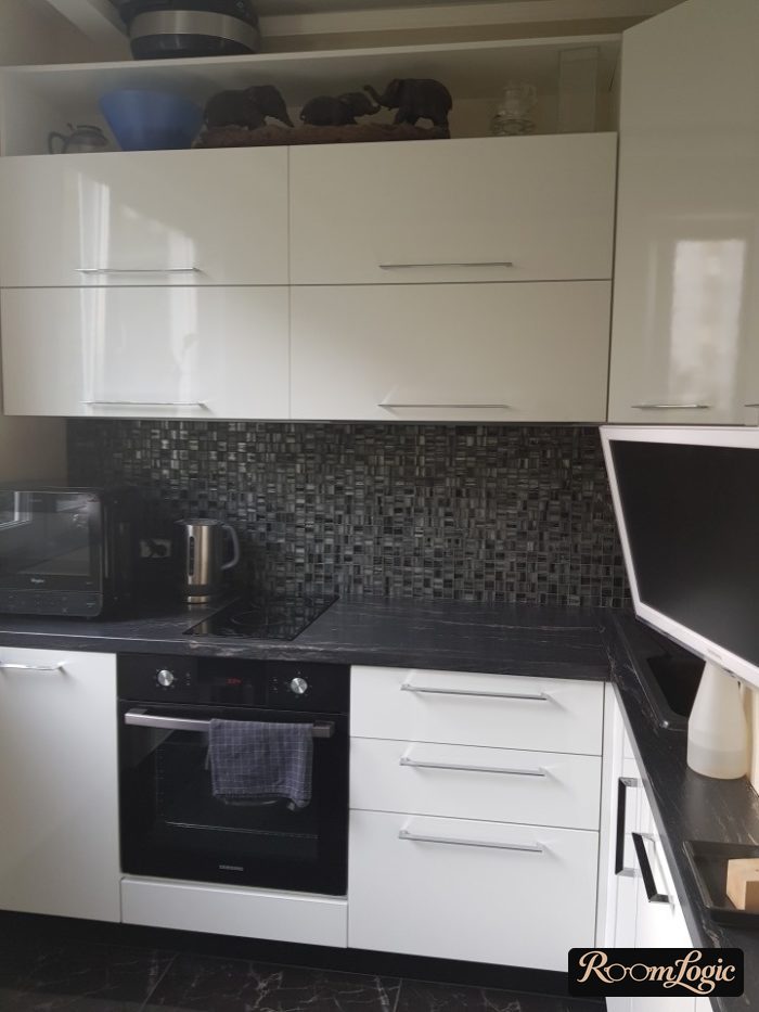 black and white small kitchen with mosaic on backsplash