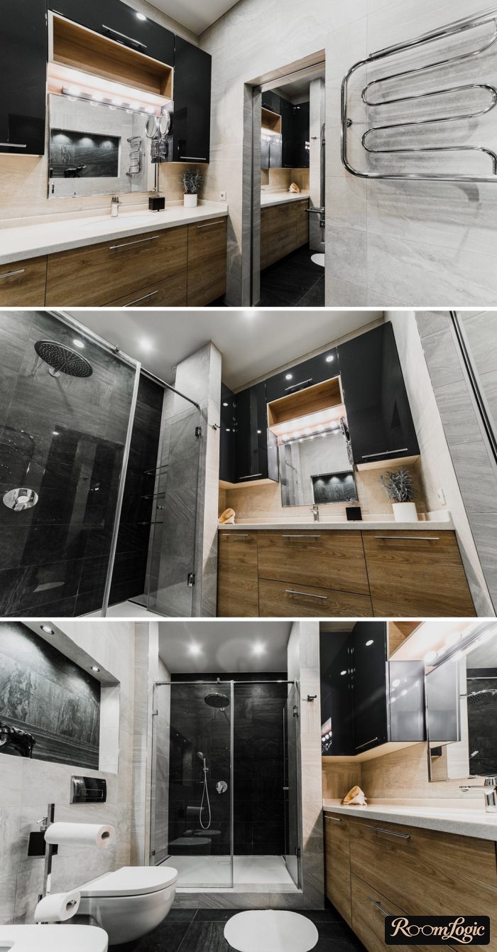 black cabinets next to the mirror in a modern bathroom