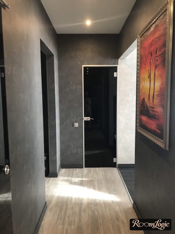 black decorative tiles in a small hallway