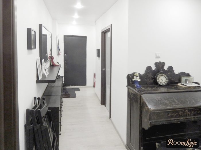 black furniture in white hallway