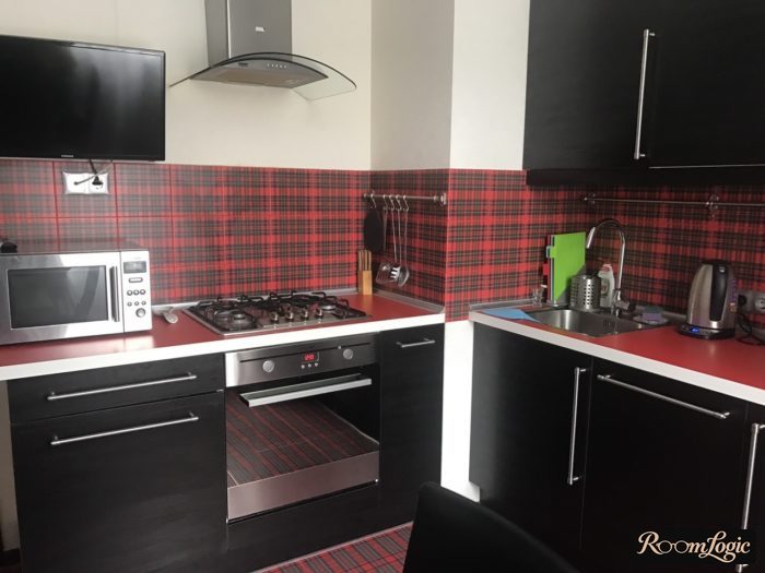 black kitchen cabinets with red backsplash