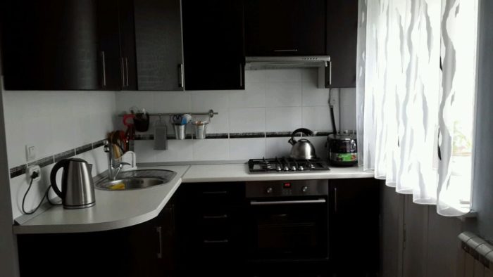 black kitchen design in tiny apartment