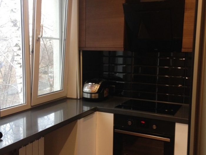 black subway tile on the backsplash in a tiny apartment