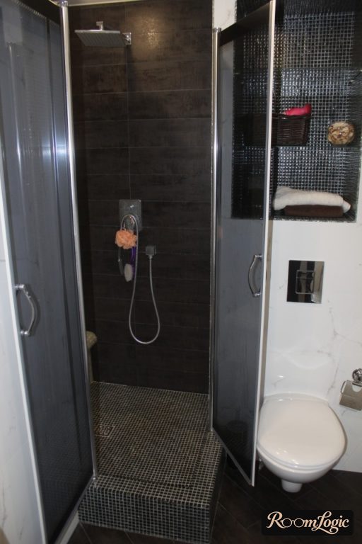 black tile and mosaic in the shower and toilet