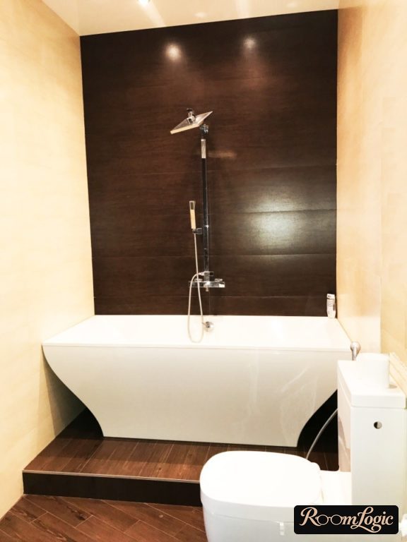 black tile wall behind the bathroom