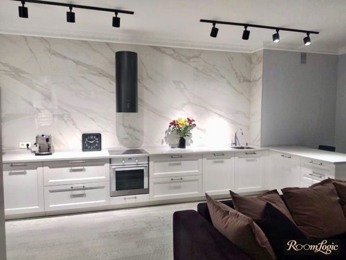 black track lights in a kitchen with no upper cabinets in a modern classic style