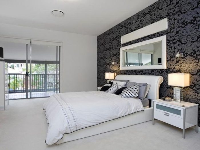 black walls with silver accents in a bedroom