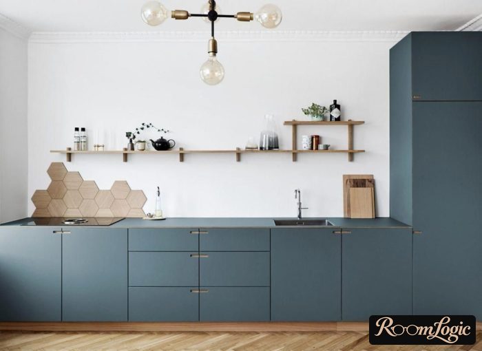 blue kitchen with open shelves and drawer next to wall