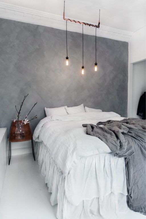 Bronze loft light fixture above the bed