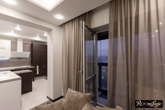 brown sheer curtain in kitchen-living room with balcony door