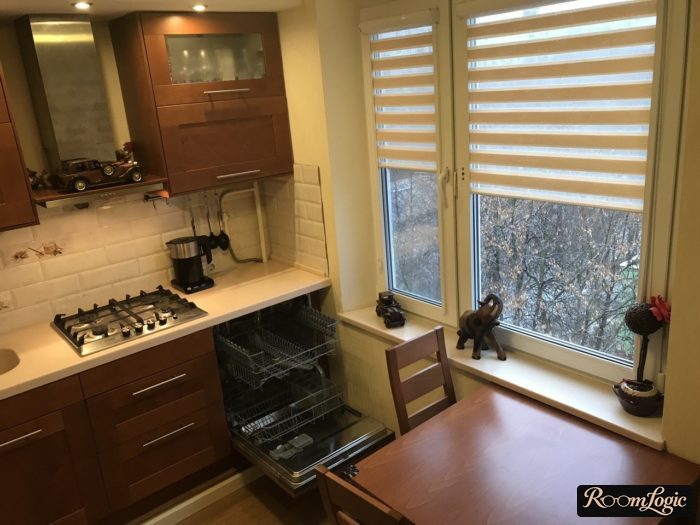 Built-in dishwasher in the kitchen cabinet against the wall