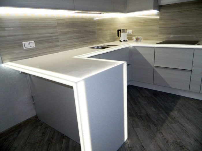 built-in LED lighting under the breakfast bar made of artificial stone