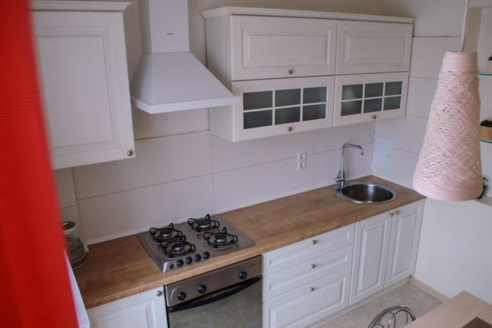 classical design white kitchen with wood-look countertop