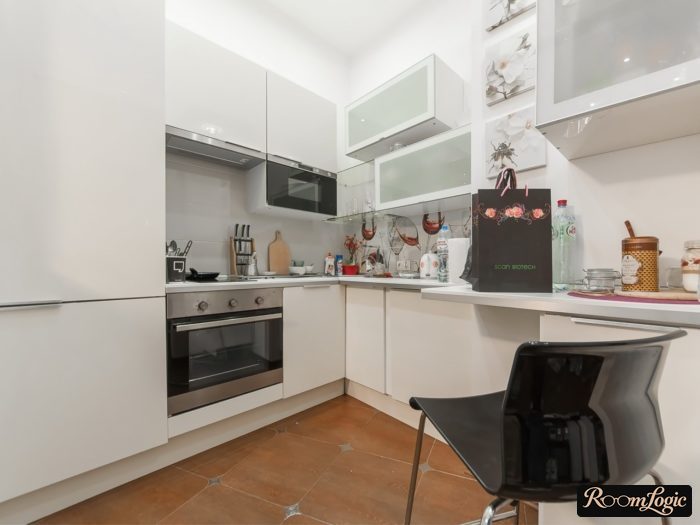 cluttered design of a small white kitchen