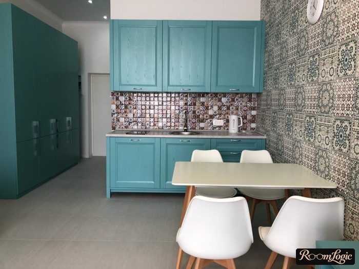 combination of bright wallpaper and tiled flooring with a pattern on the kitchen