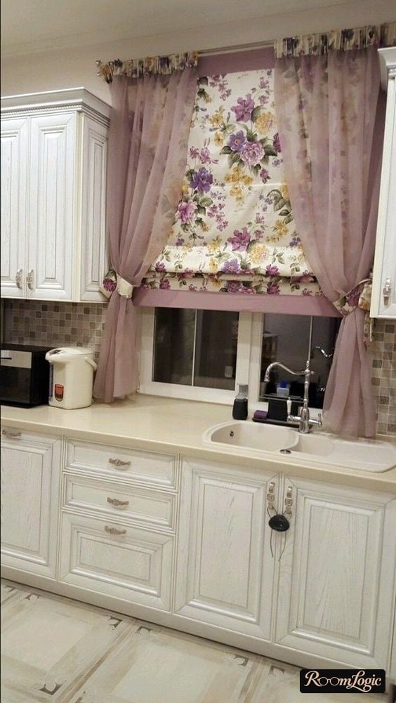 combination of floral roman shades and short sheer curtains on the kitchen