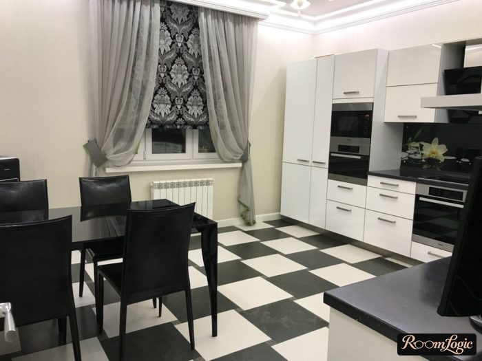 combination of roman shades and gray sheer curtains on a white kitchen