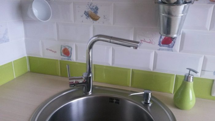 Combination of several types of white subway tile on the backsplash