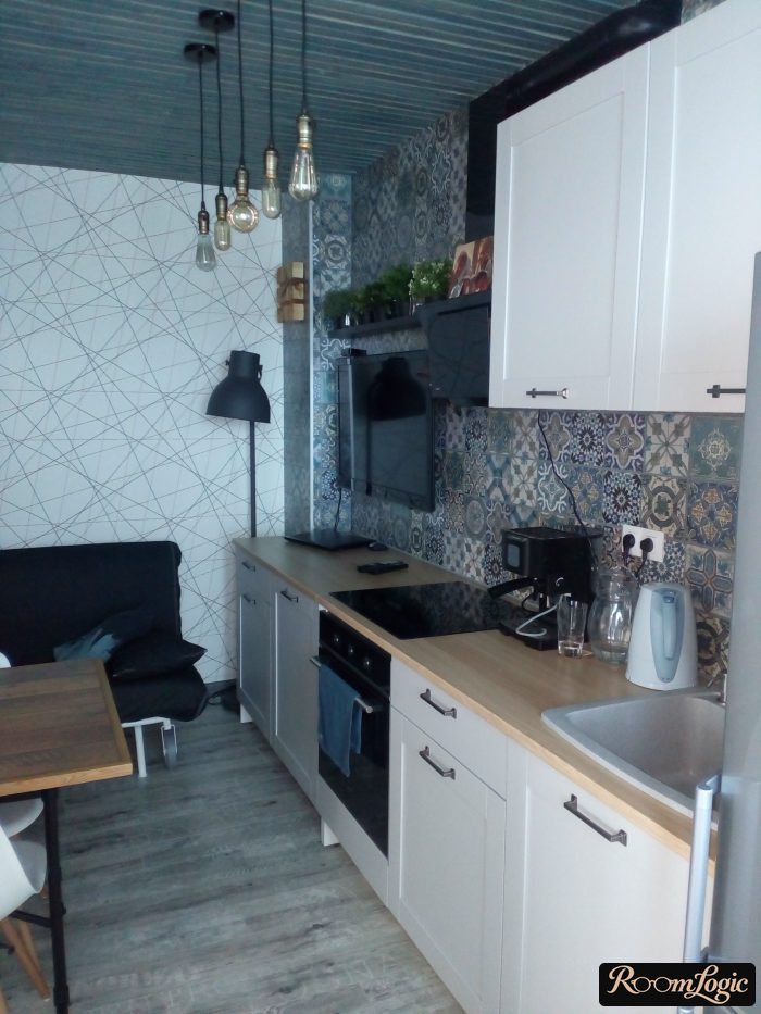 combination of wallpaper with intersecting lines and tiled flooring with a pattern in the kitchen
